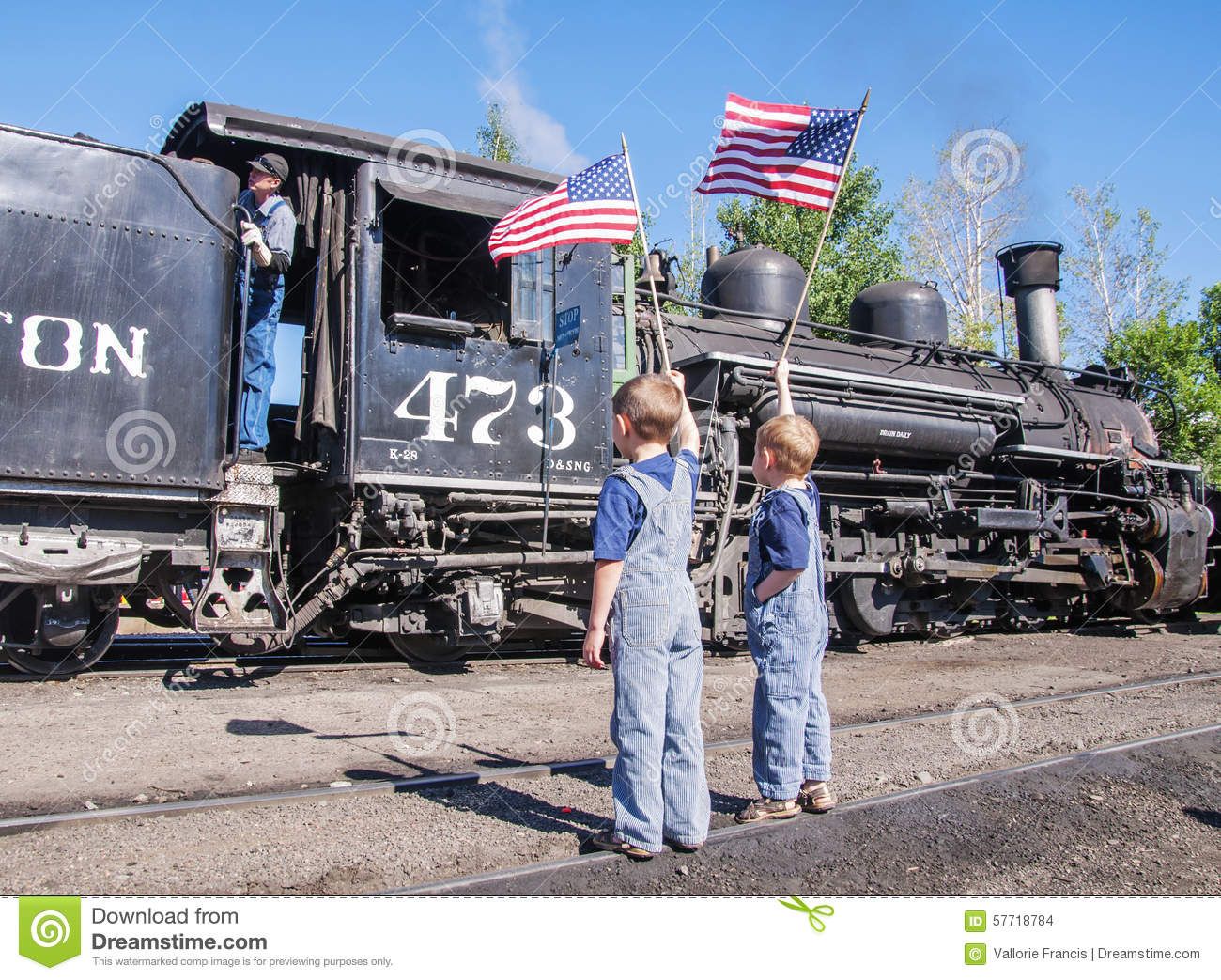 boys-waving-american-flags-train-engineer-two-young-standing-tracks-wearing-overalls-wave-gets...jpg