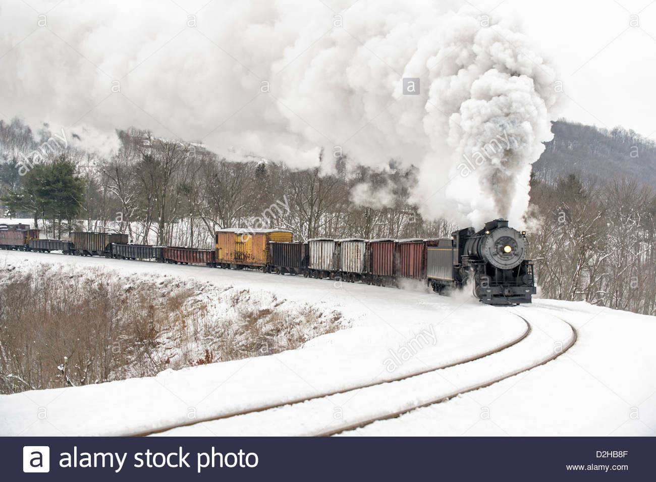 steam-locomotive-and-frieght-train-rounding-curve-in-winter-snow-with-D2HB8F.jpg